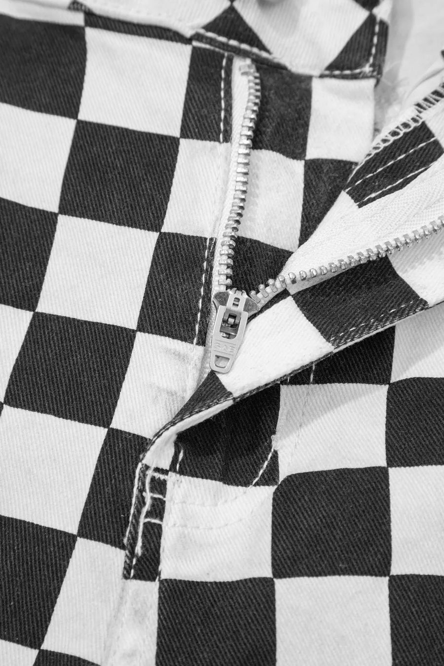 Checkerboard distressed cropped jeans with a zipper fly detail.