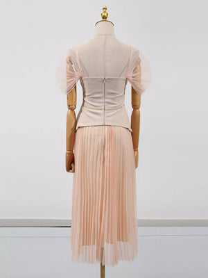 Embroidered tulle midi dress with sheer puff sleeves and a pleated skirt in a soft pink hue.