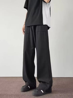 Black casual wide-leg cargo pants with flap pockets on a man.