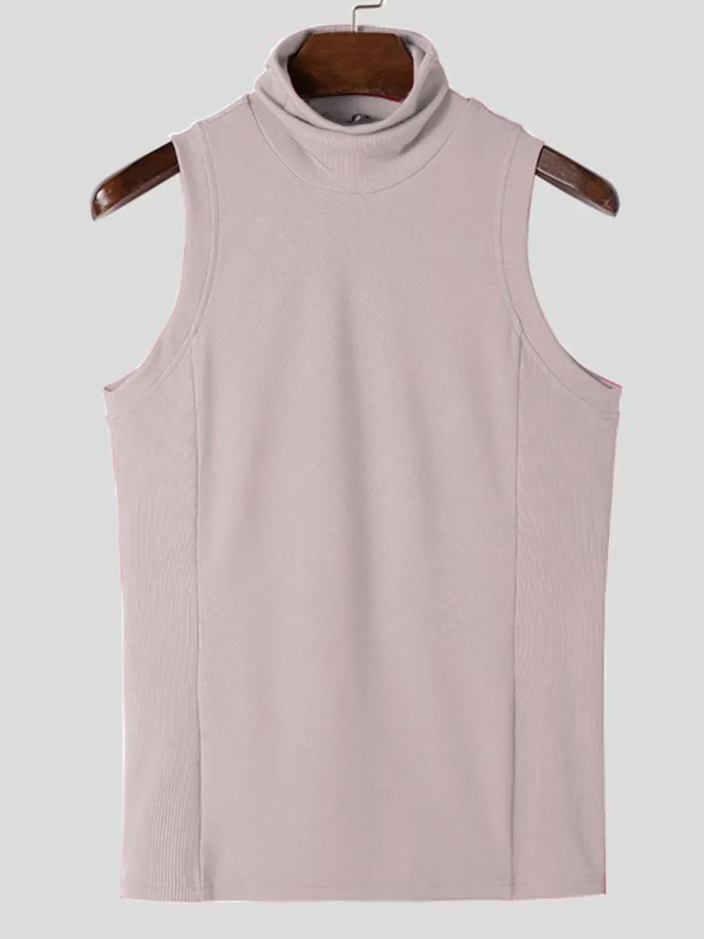 Sleeveless ribbed turtleneck shirt in blush pink with a high neckline.