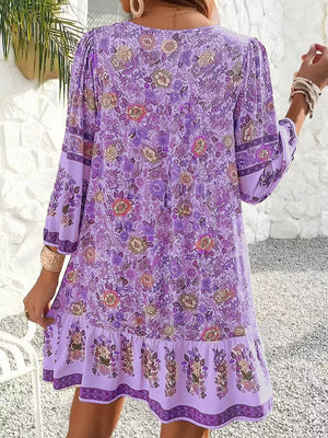 Purple floral mini dress with tiered ruffle hem and bell sleeves.