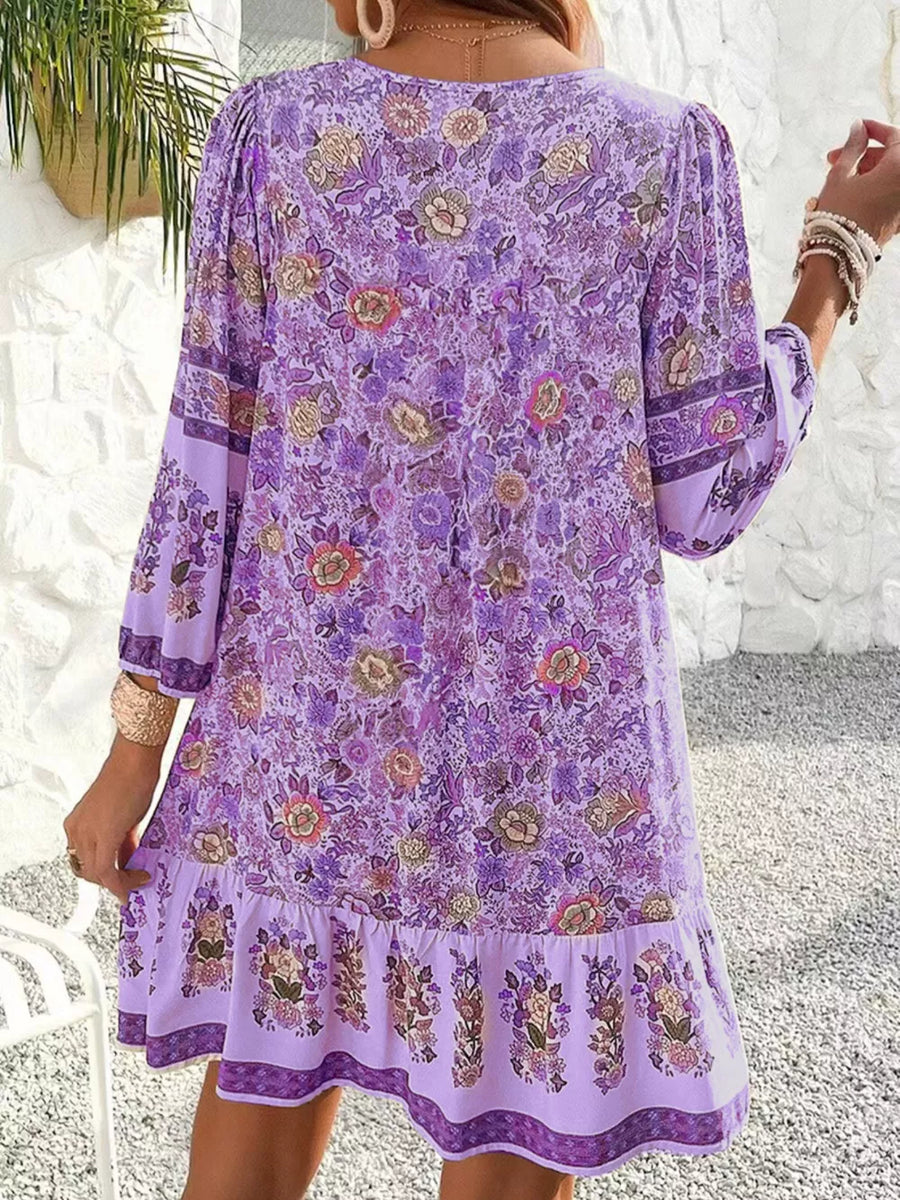 Purple floral mini dress with tiered ruffle hem and bell sleeves.