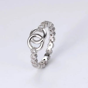 Silver eternity ring with interlocking circles and pavé cubic zirconia details.
