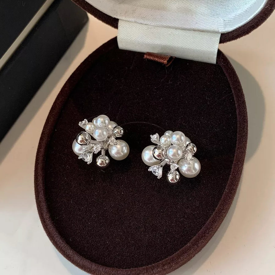 Elegant pearl cluster earrings with zircon accents in white and light gray.