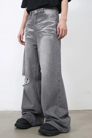 Distressed dark gray wide-leg denim jeans with a ripped knee detail.