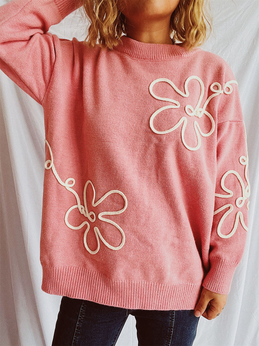 Watermelon pink acrylic knit sweater with white floral outline detail.