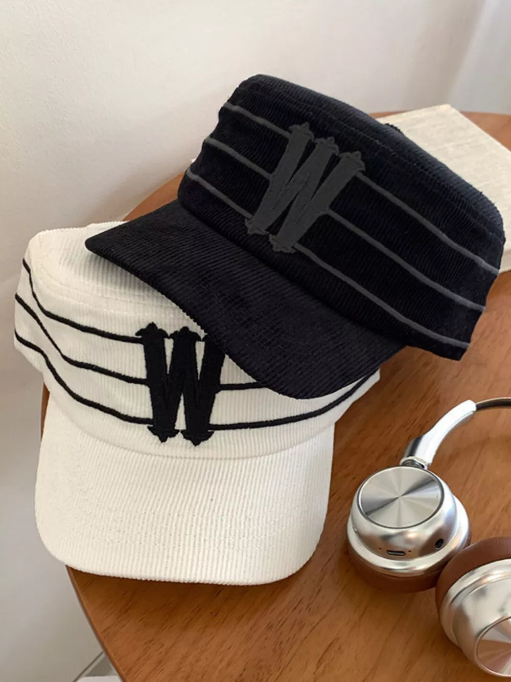 Striped cotton baseball caps in black and white with embroidered W detail.