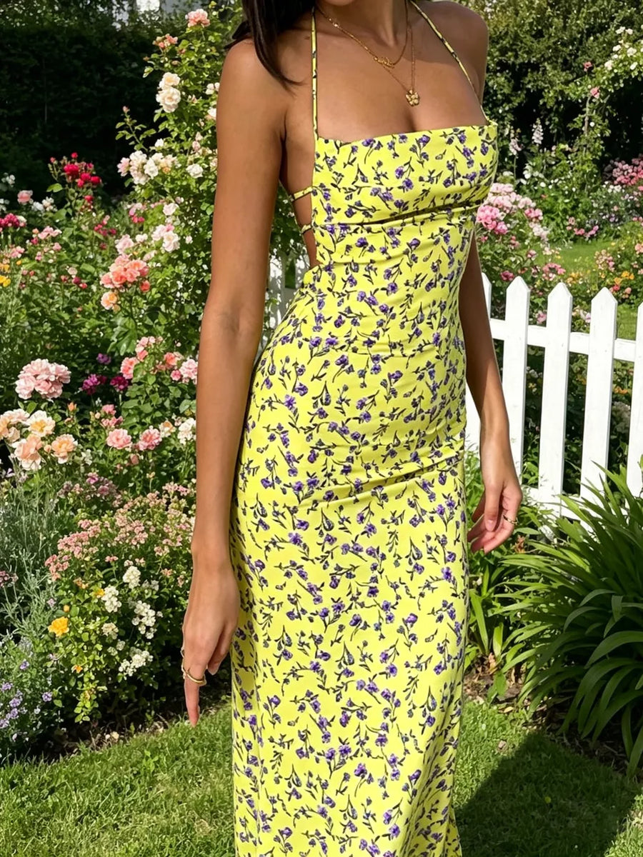 Yellow floral halter neck backless midi dress with purple floral print and tie detail.