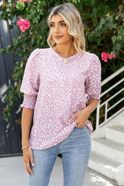 Blush pink blouse with white spot print, shirred sleeves, and puff shoulders.