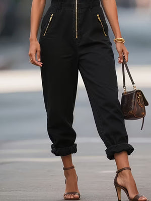 Black zip-up romper with gold zipper details and cuffed ankles