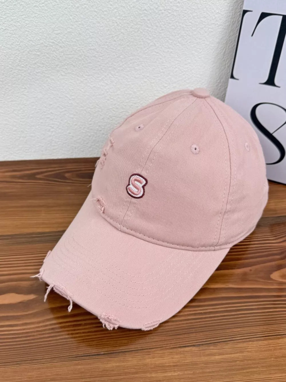 Pink distressed baseball cap with embroidered S detail