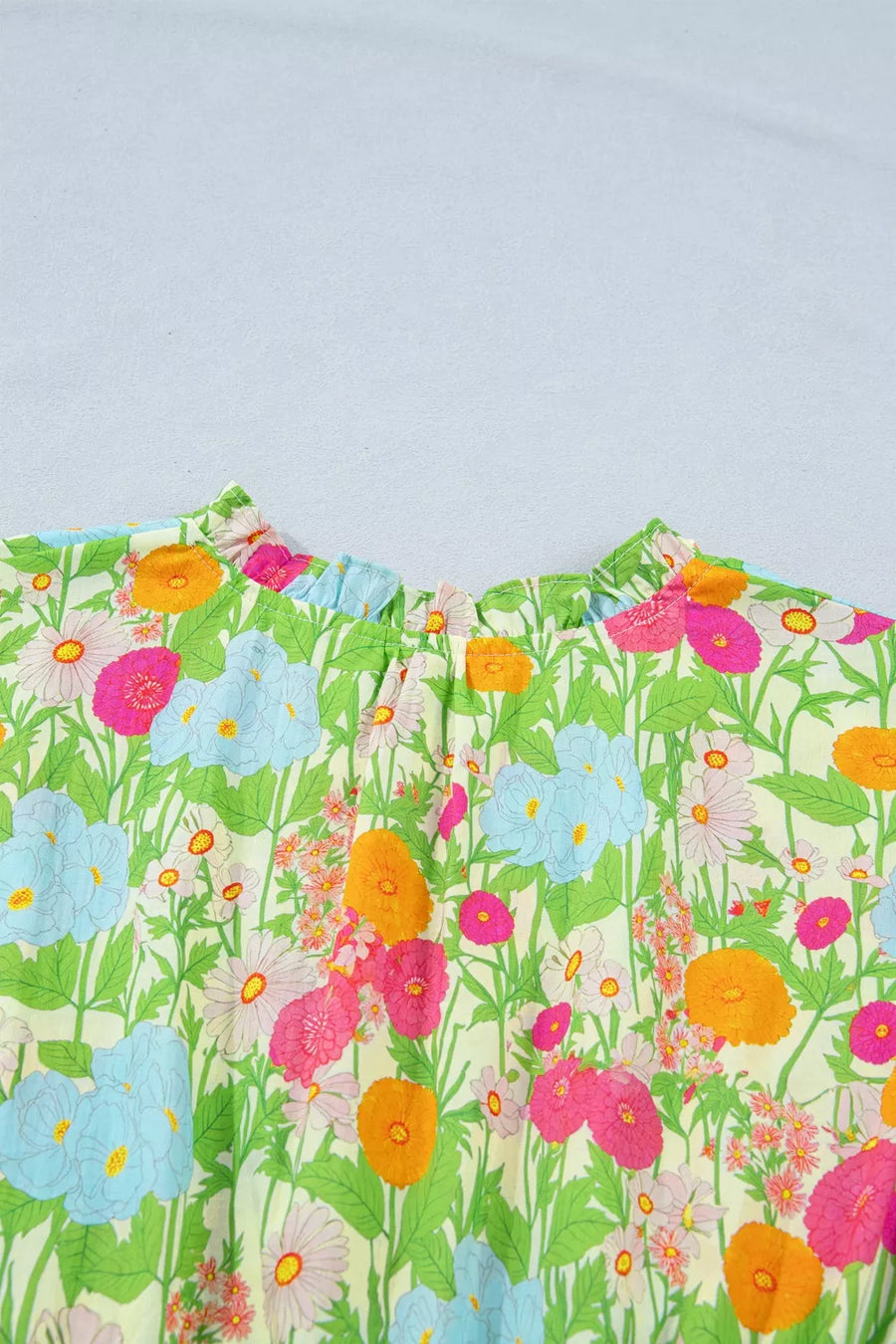 Maxi dress with vibrant floral print, ruffled neckline, and comfortable cotton fabric.