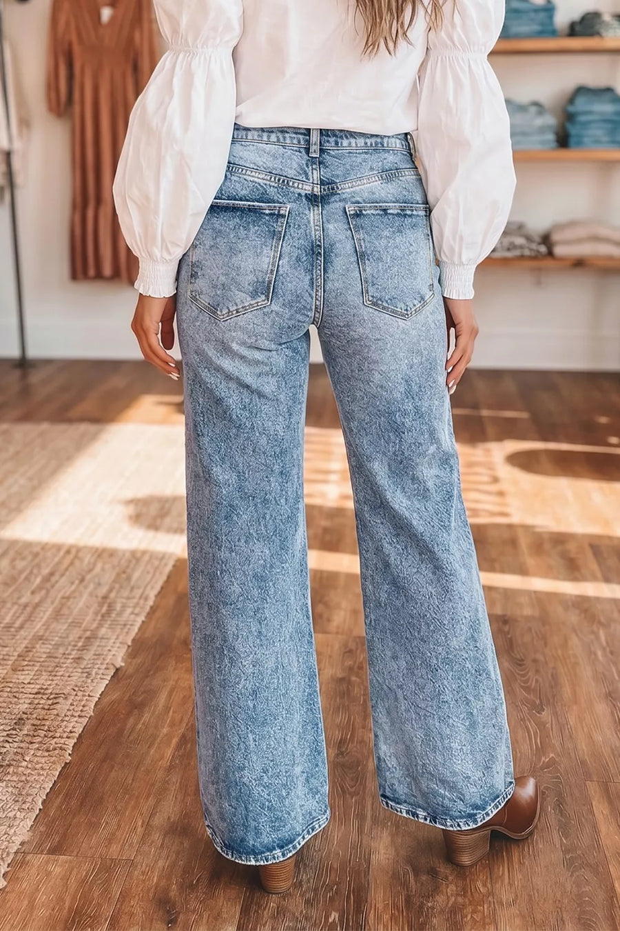 Wide leg jeans in acid wash denim with a high rise and distressed details.