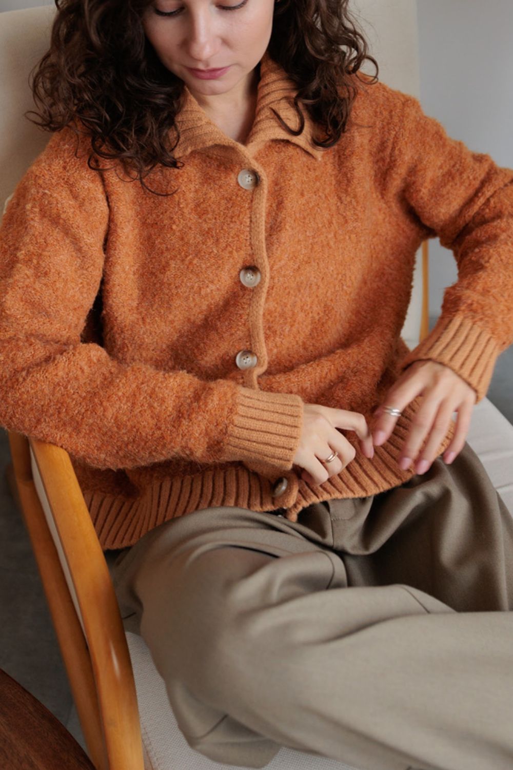 Textured bouclé collar cardigan in tangerine with button front and ribbed cuffs.