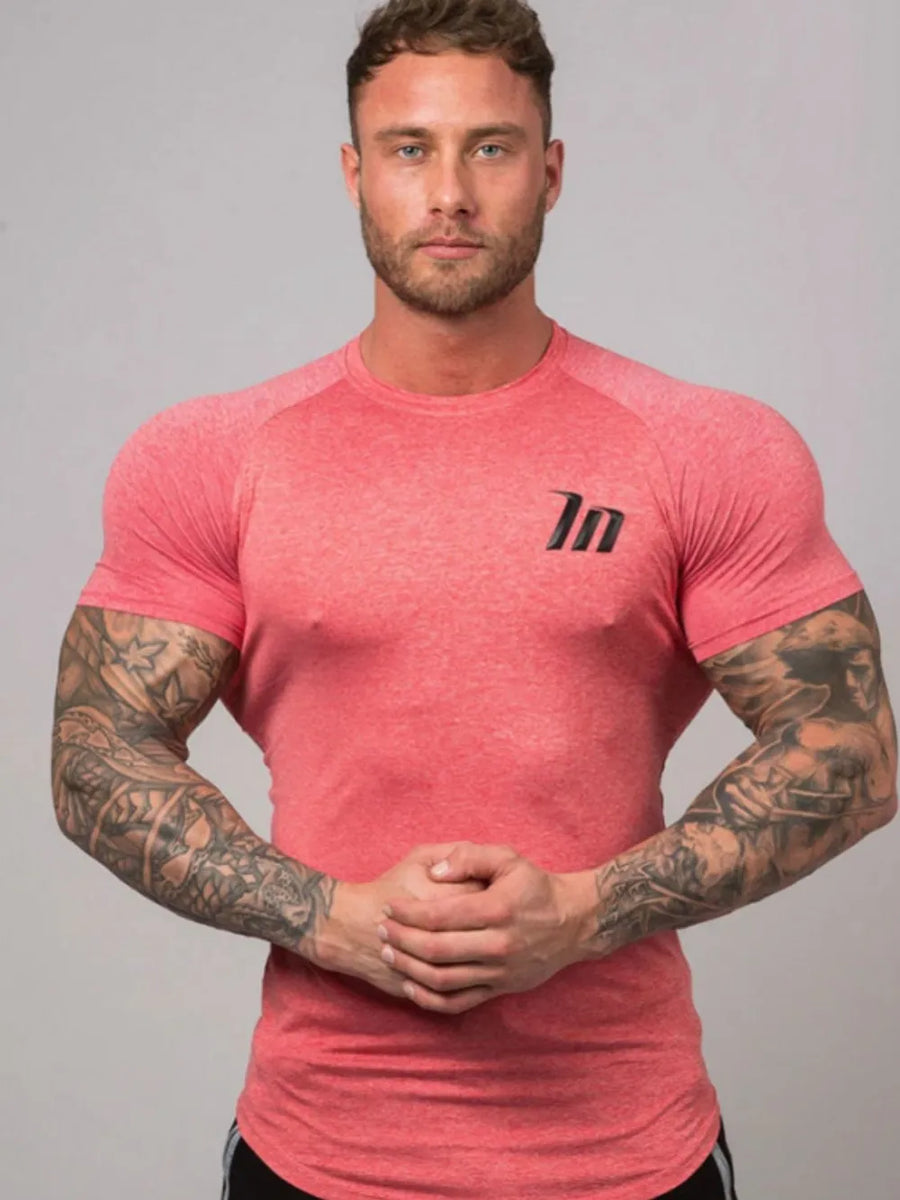 Burnt Coral raglan tee with black logo detail, crew neck, short sleeves, performance fit.