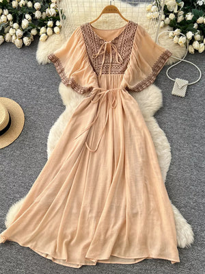 Peach V-neck maxi dress with embroidered yoke and flutter sleeves, tie waist, boho style