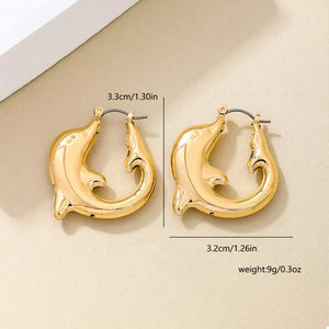 Gold dolphin hoop earrings with a polished finish.