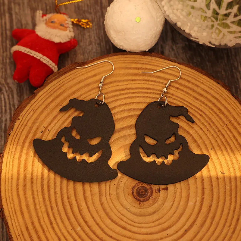 Black leather witch hat earrings with carved jack-o'-lantern faces
