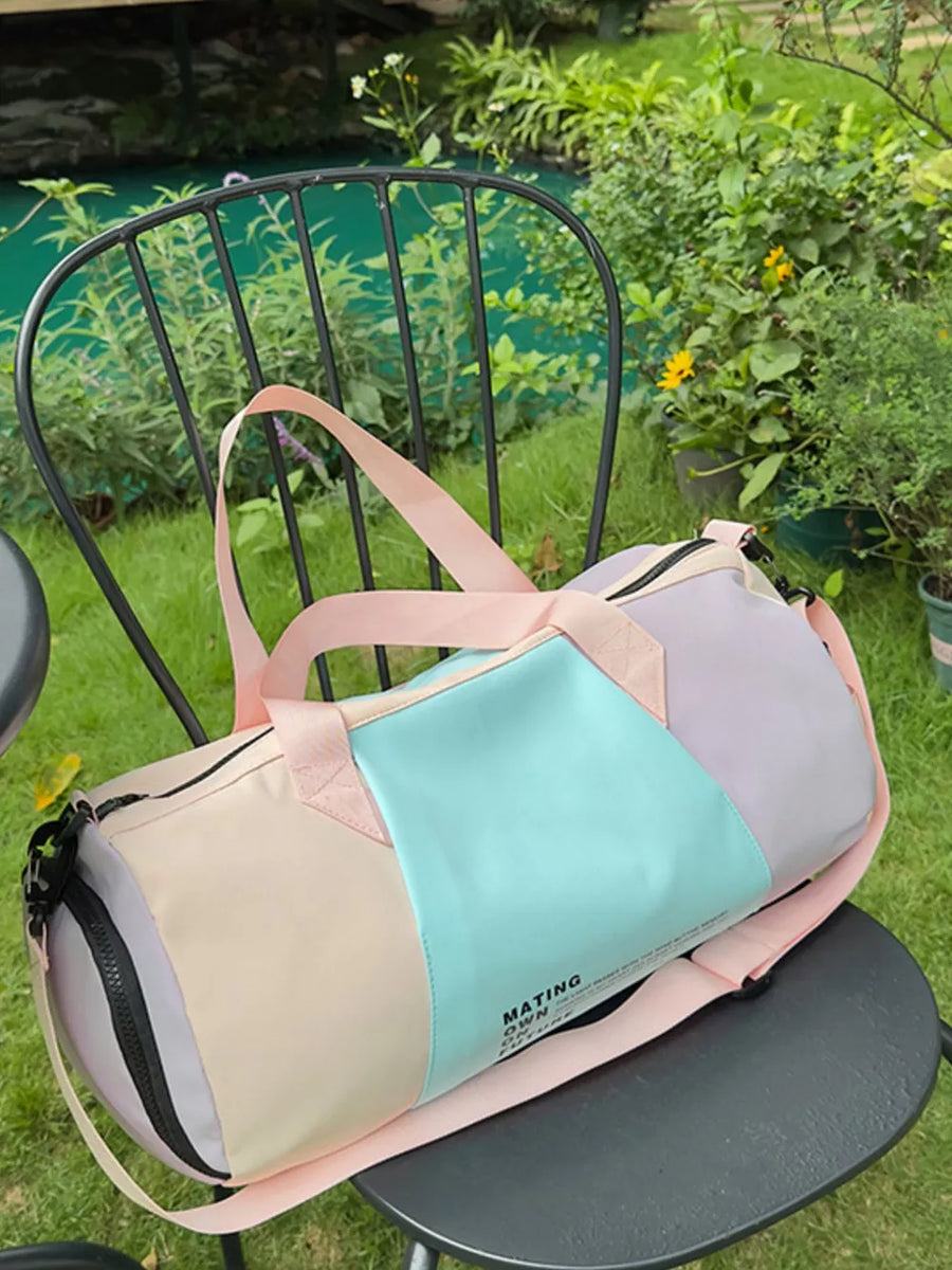 Vibrant pastel nylon duffle bag with color-blocked panels and adjustable strap.