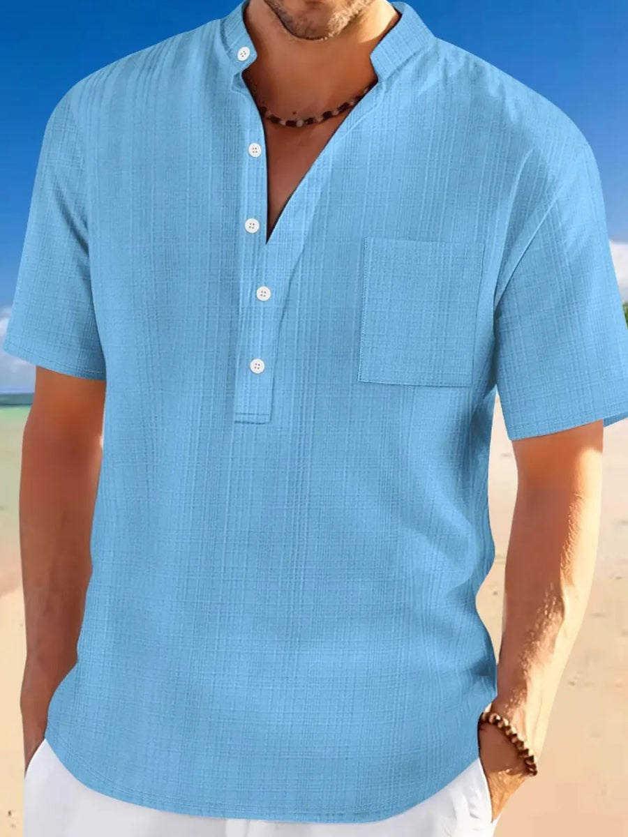 Sky blue textured linen henley shirt with mandarin collar and chest pocket.