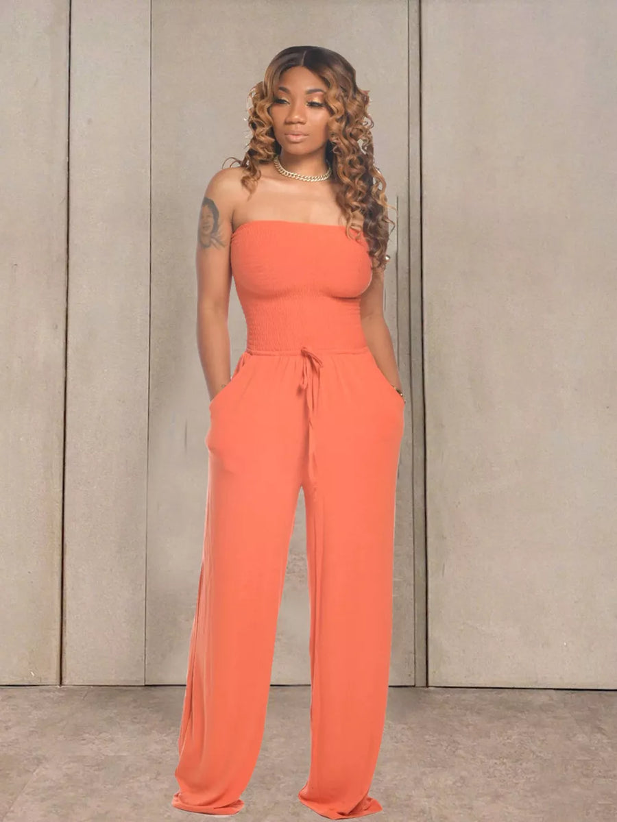 Orange strapless smocked bodice jumpsuit with wide legs and drawstring waist