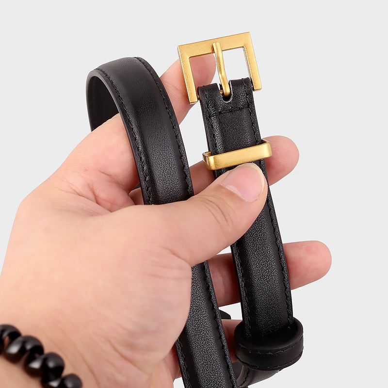 Black leather skinny belt with a golden square buckle and keeper.