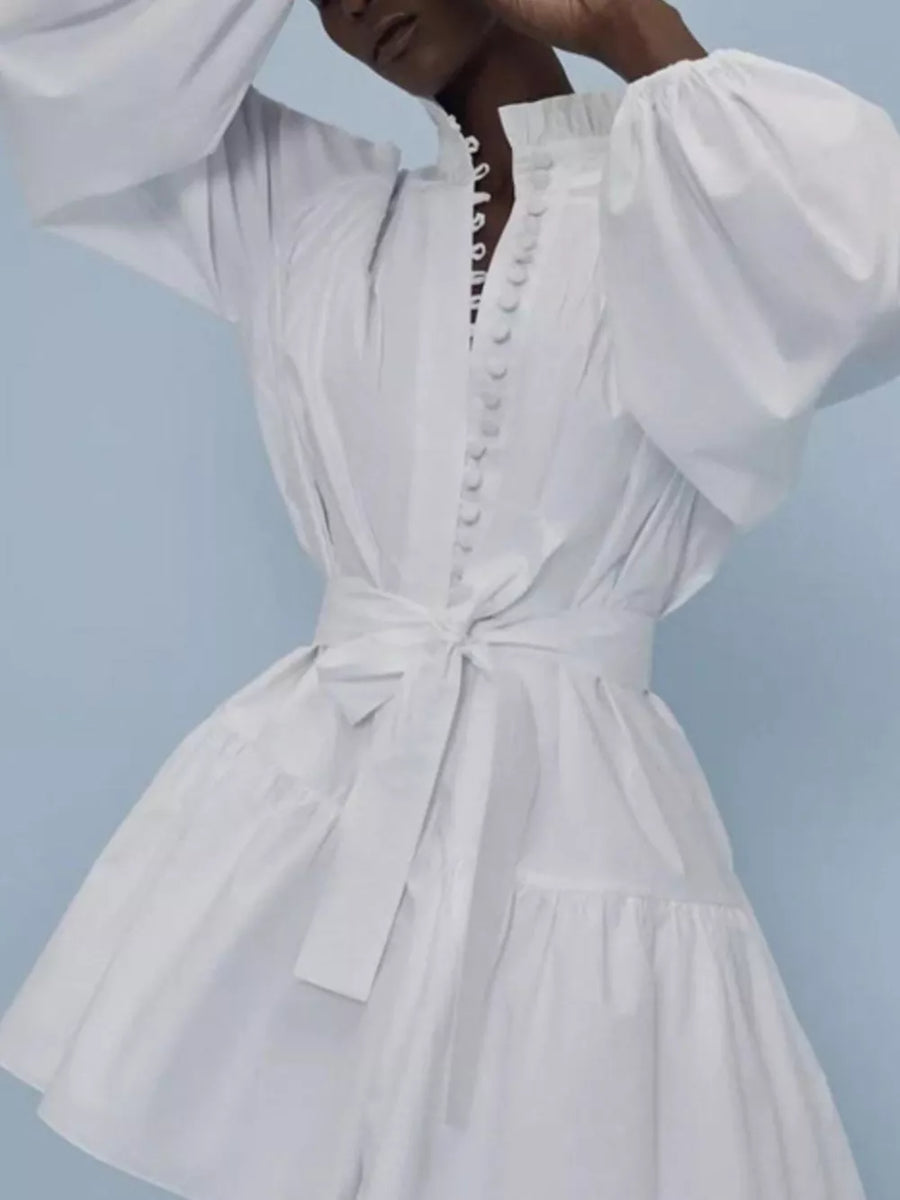 White cotton dress with ruffled collar, balloon sleeves, button front, and tie waist