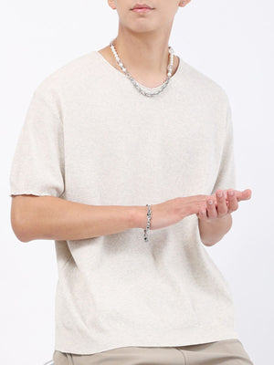 Men's cream knit t-shirt with short sleeves and a textured weave.