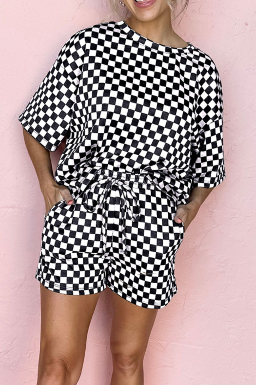 Black checkered loungewear set with short sleeves and drawstring shorts.