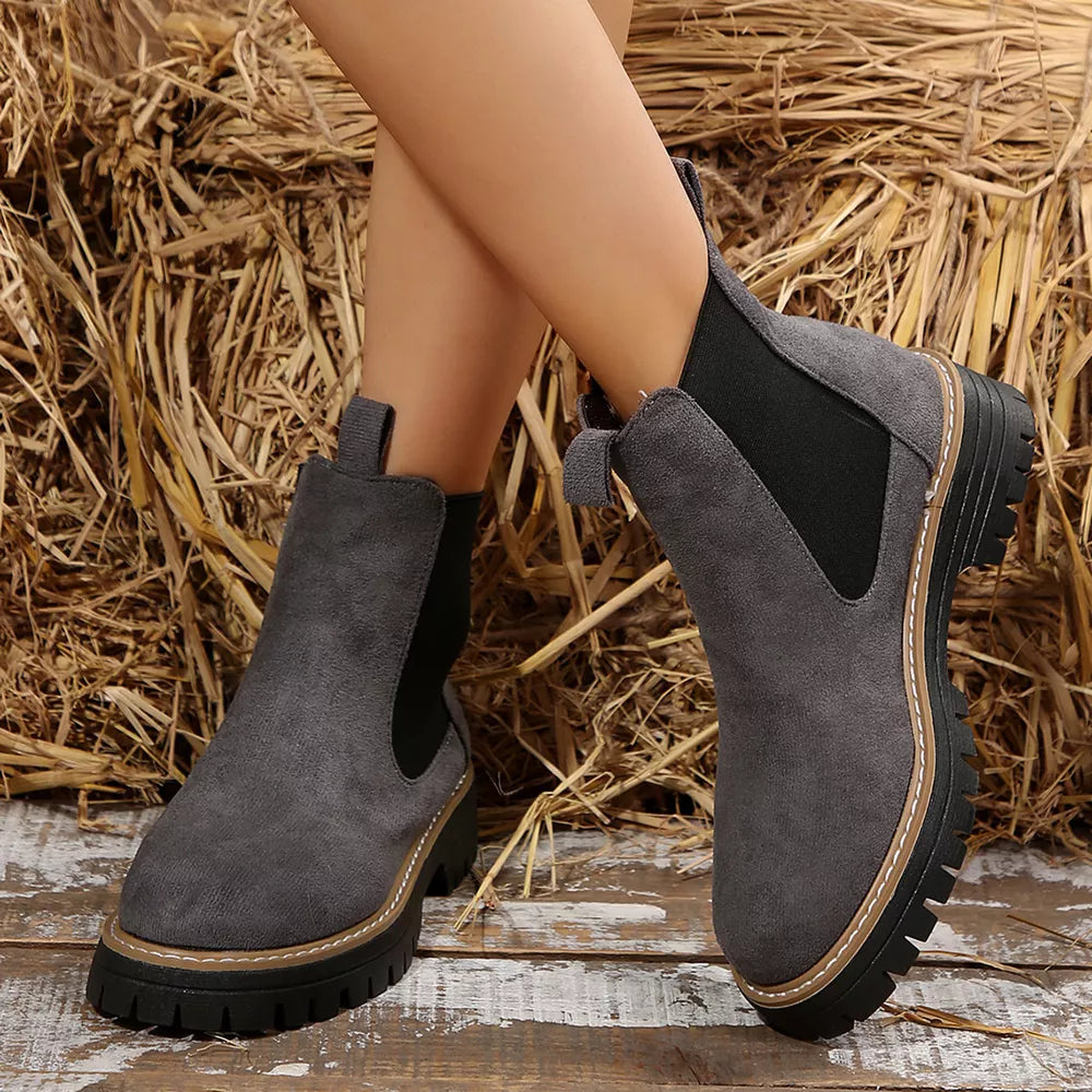 Gray suede platform ankle boots with chunky sole and elastic side panels.