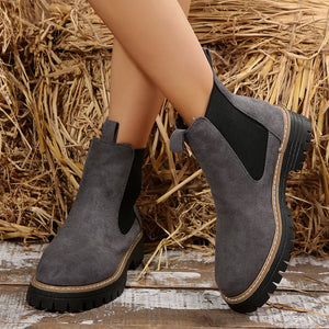Gray suede platform ankle boots with chunky sole and elastic side panels.