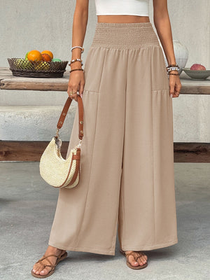 Smocked waist wide leg cotton pants in beige with front pockets.