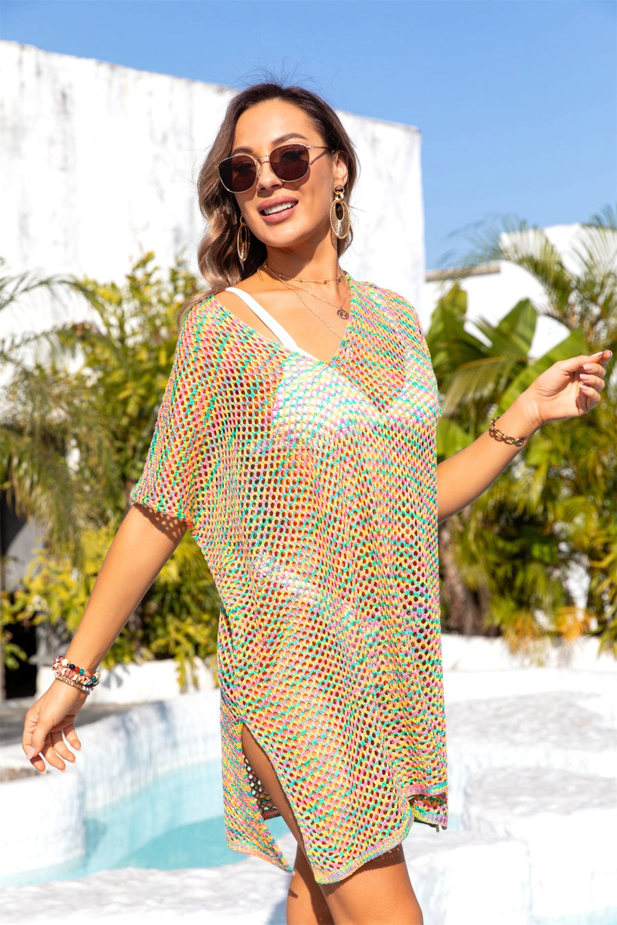 Rainbow crochet tunic cover-up with V-neck, short sleeves, and side slits.