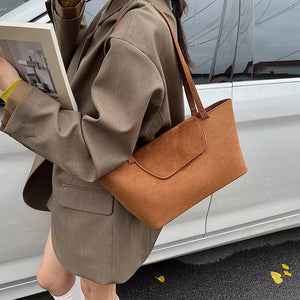 Suede flap tote bag in brown with a clean, minimalist design.