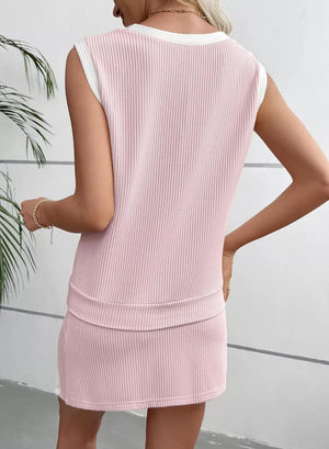 Pink ribbed knit sleeveless top with white trim and matching skort.