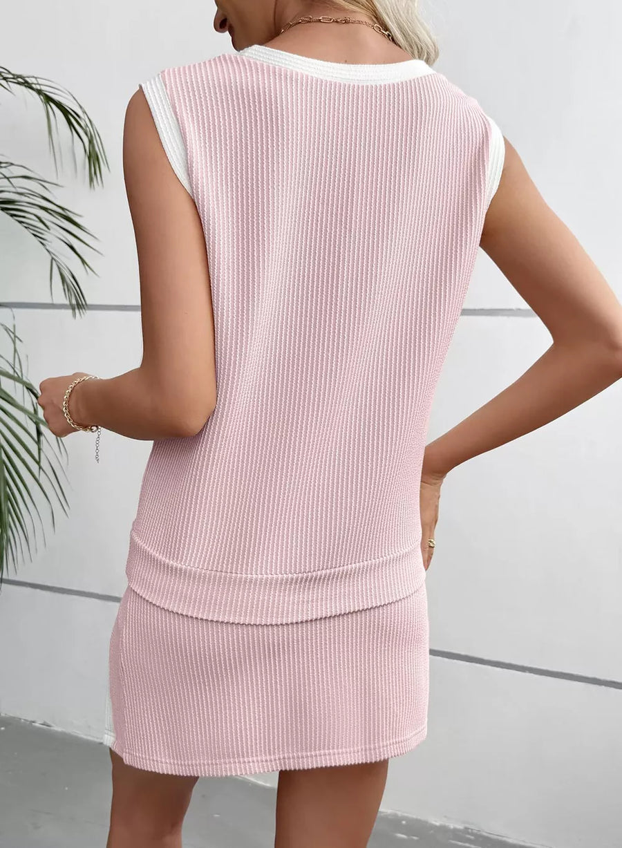 Pink ribbed knit sleeveless top with white trim and matching skort.