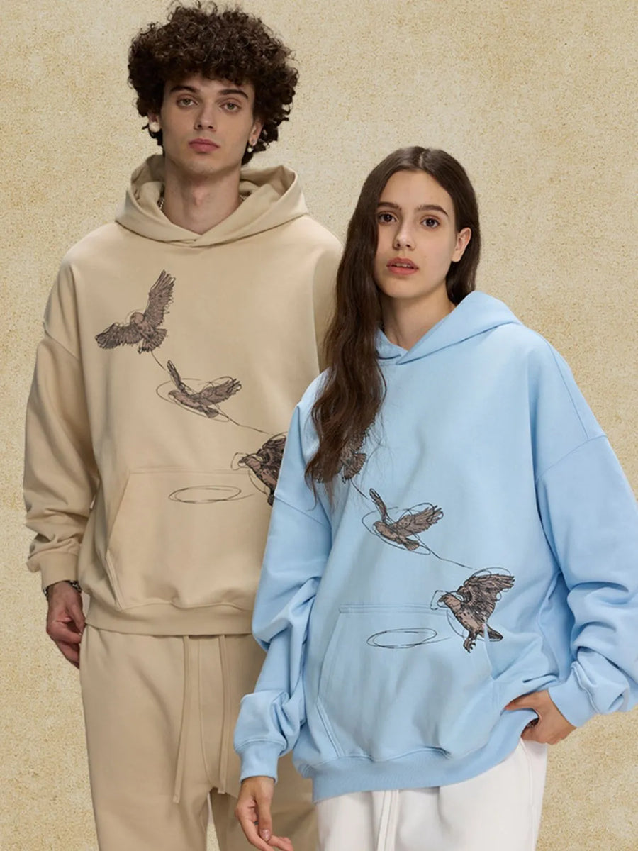 Light blue relaxed fit hoodie with embroidered bird graphic.