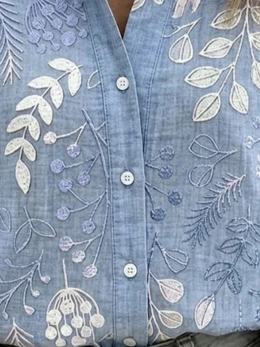 white button-down shirt featuring buttoned and floral