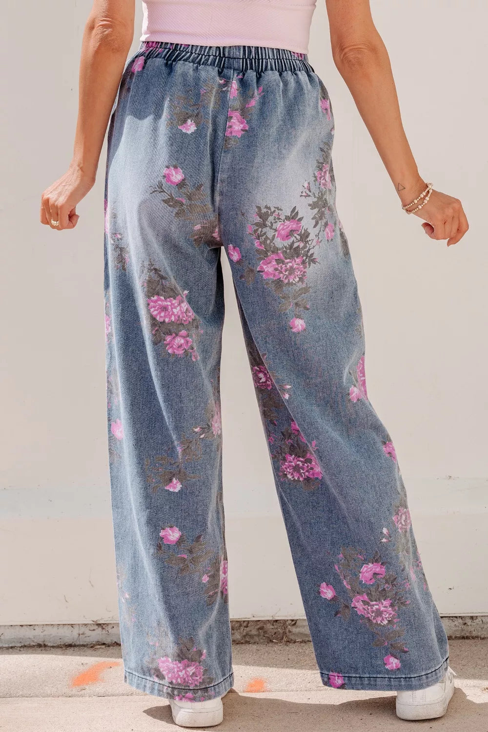 Floral wide-leg denim jeans with elastic waistband and pink floral print.