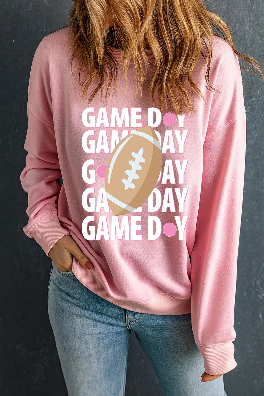 Blush pink ribbed long sleeve sweatshirt with Game Day football graphic and pink dots.