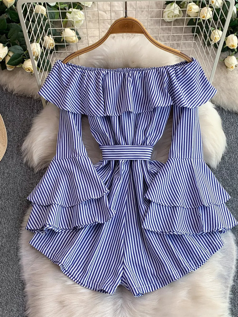 Blue striped off-shoulder ruffled romper with bell sleeves and a belted waist.