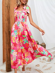 Tropical tie-strap smocked midi dress in strawberry with a tiered skirt and floral print.