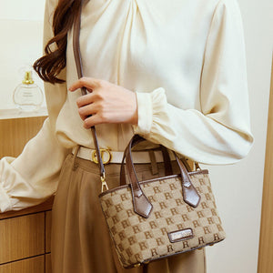 crossbody bag in tan with monogram and top handles