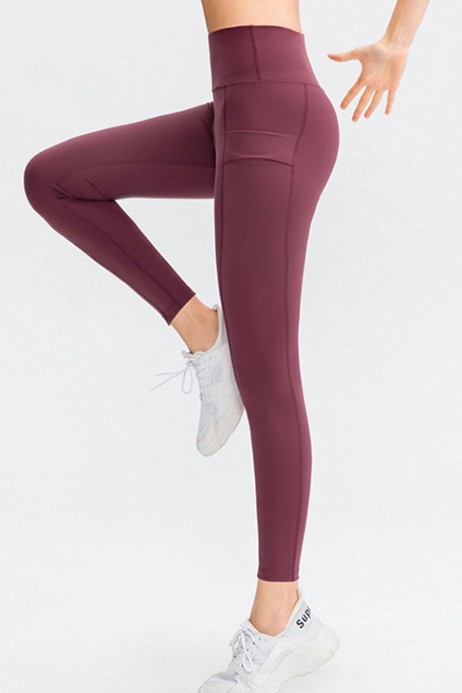 Wine athletic leggings with side pockets and a high waist.