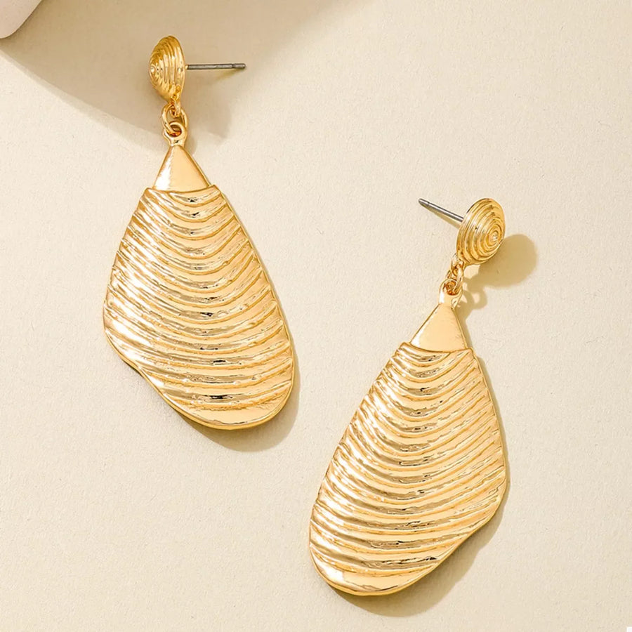 Textured gold dangle earrings with a ribbed, teardrop-shaped pendant.