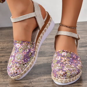 Floral espadrille sandals in purple with ankle strap and woven jute sole.