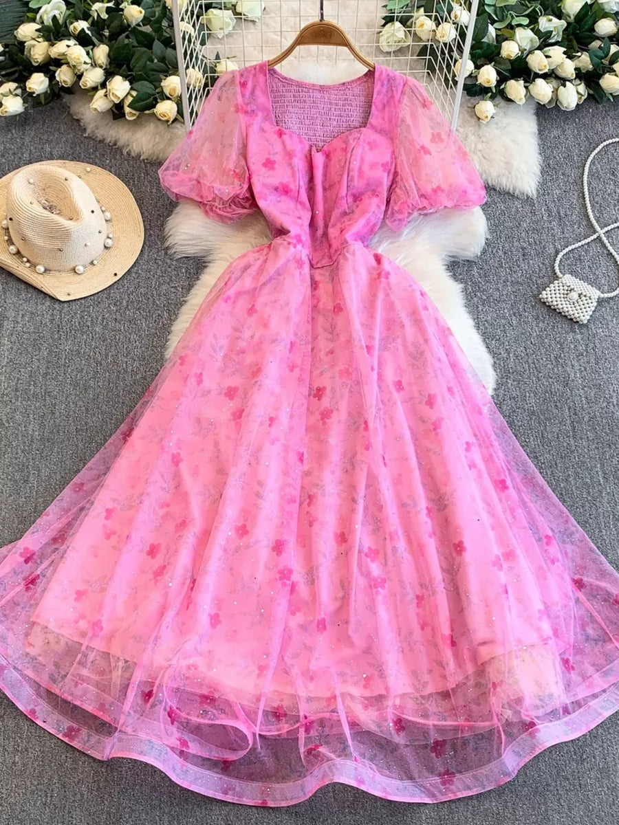 Pink floral a-line maxi dress with sweetheart neckline and puff sleeves.