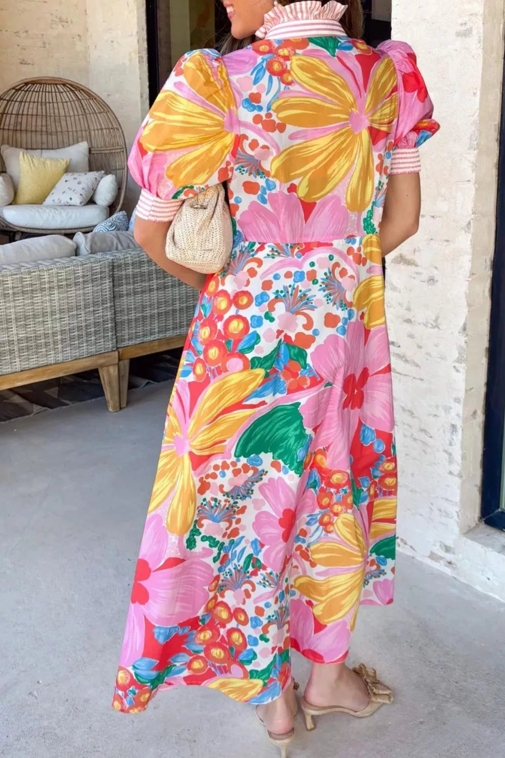 Maxi dress with vibrant floral print, puff sleeves, and striped detail on cuffs and collar.