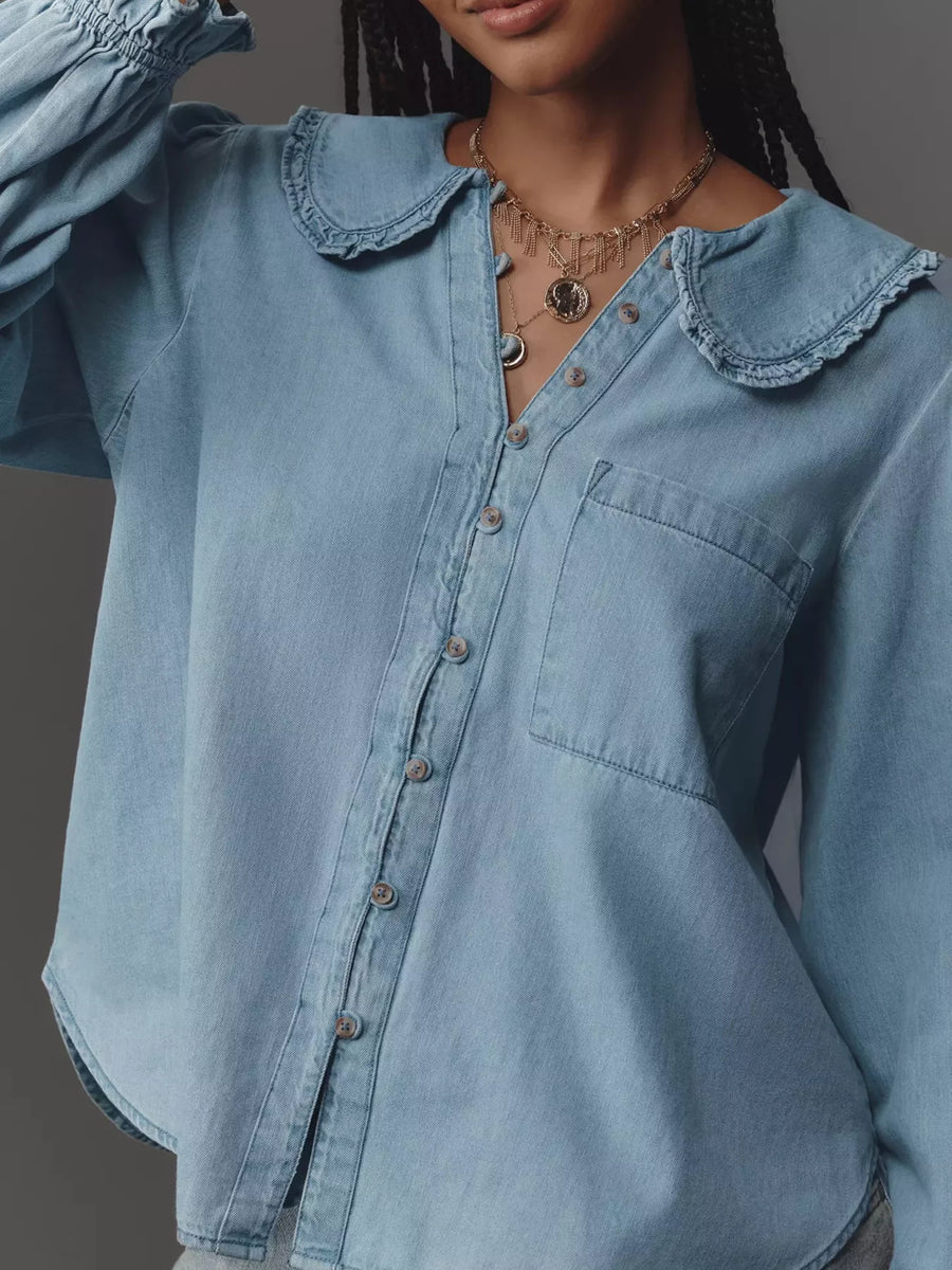 Blue denim shirt with ruffled Peter Pan collar and button-up front.