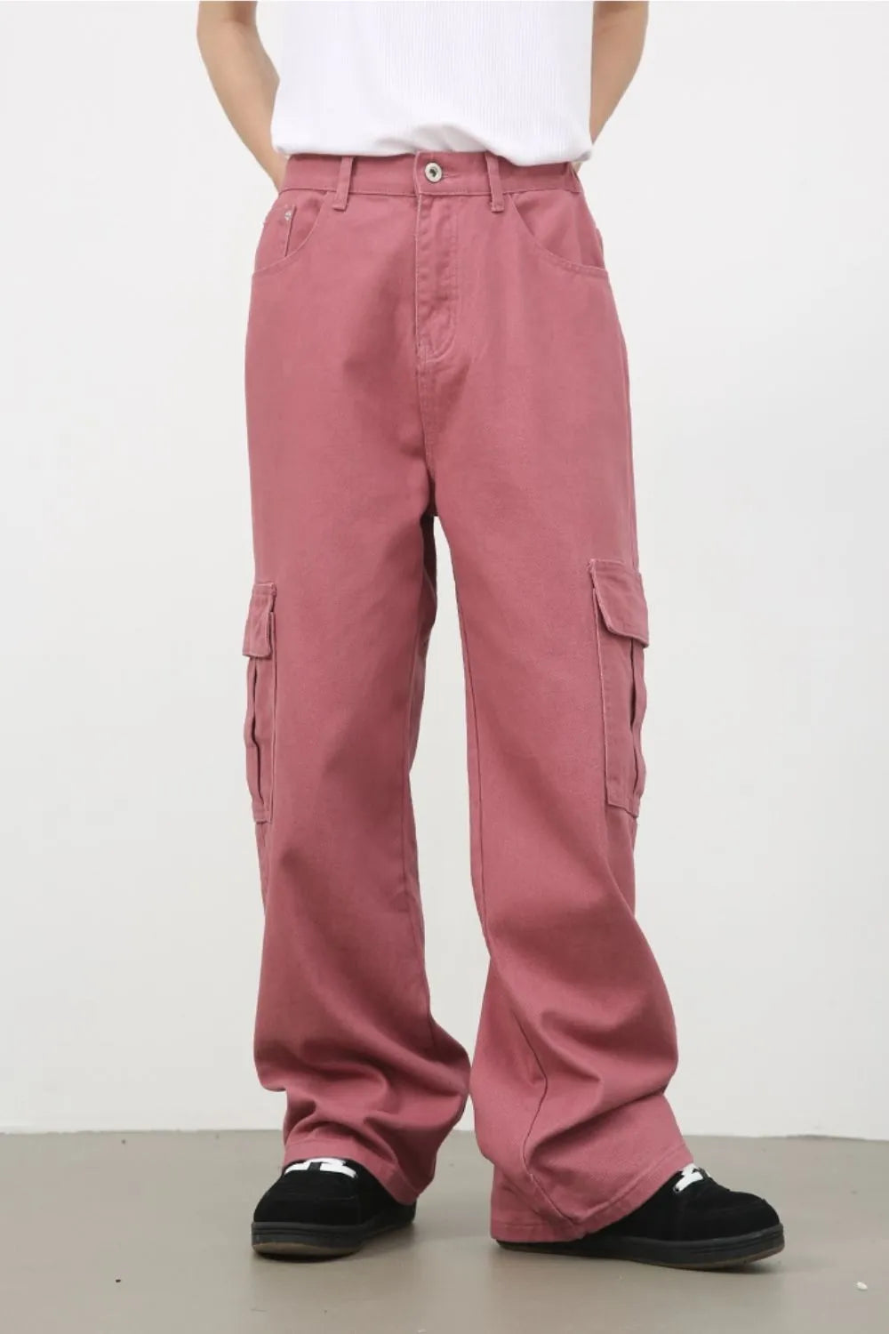 Dusty rose wide-leg cargo pants with multiple pockets and a relaxed fit.